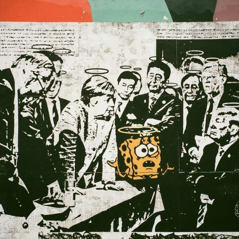 Philbillys community A black-and-white photo of a group of people with a bright cartoon character in the centre.